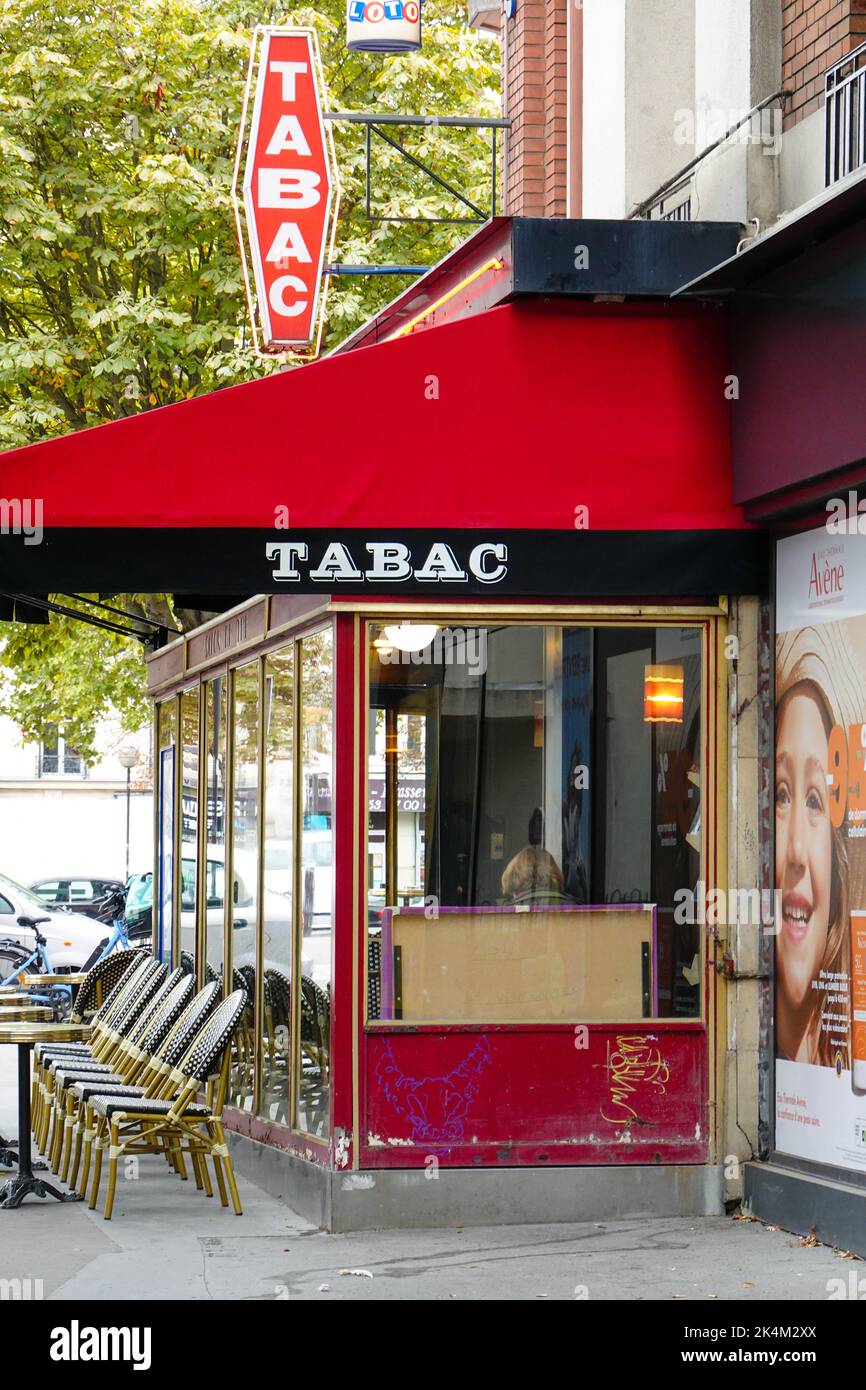 Café-tabac, bar, cafe, also selling cigarettes, lottery tickets and sometimes stamps, notable by the red diamond-shaped sign outside, Paris, France. Stock Photo