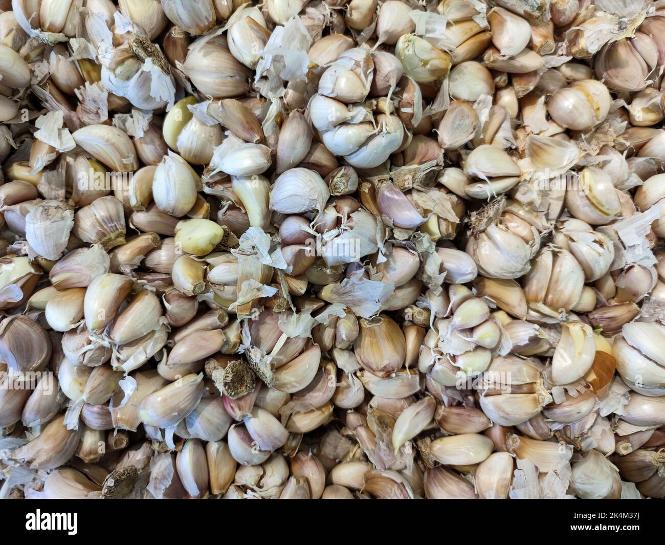 Close up of pile of garlic cloves at a stall of supermarket in Asia