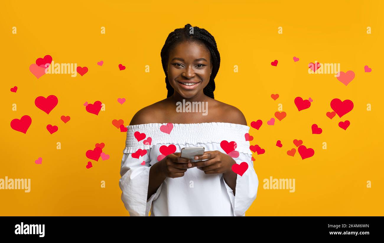 Portrait Of Happy Young Black Woman Holding Smartphone, Yellow ...