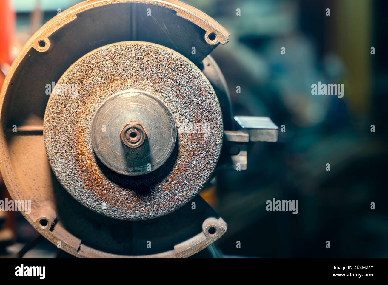 Sharpening knife on old grindstone wheel Stock Photo - Alamy