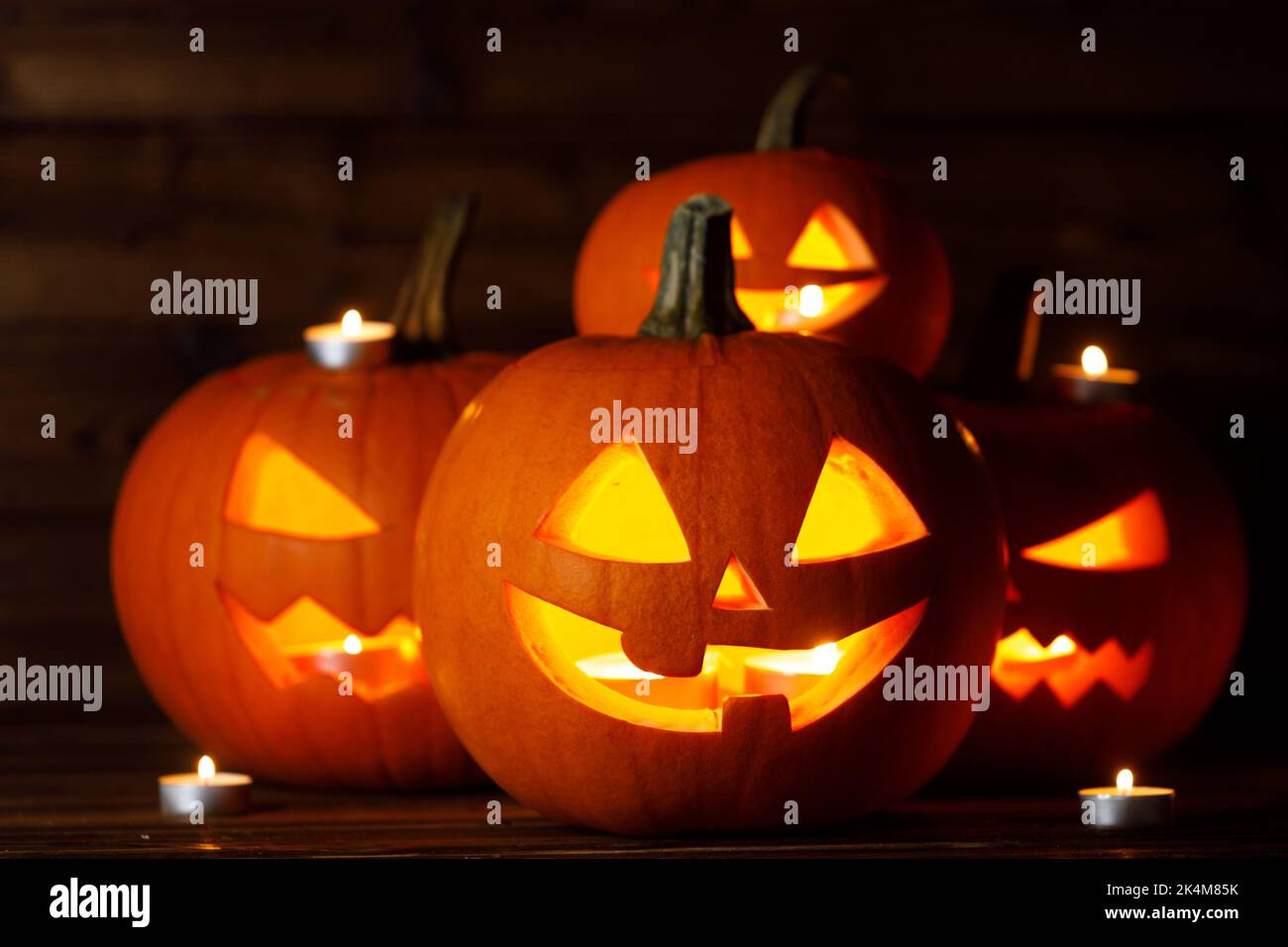 Halloween Jack O Lantern pumpkins and burning candles traditional decoration Stock Photo