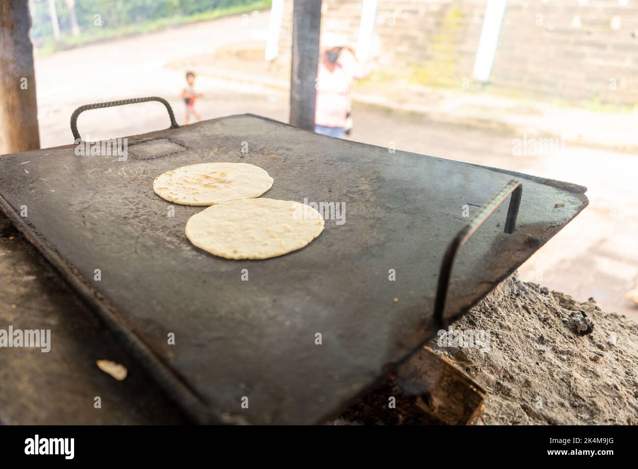 Corn tortillas on a metal griddle. Latin American cuisine Stock Photo