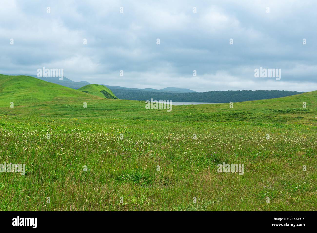 beautiful landscape of Kunashir island with grassy hills and distant lake Stock Photo