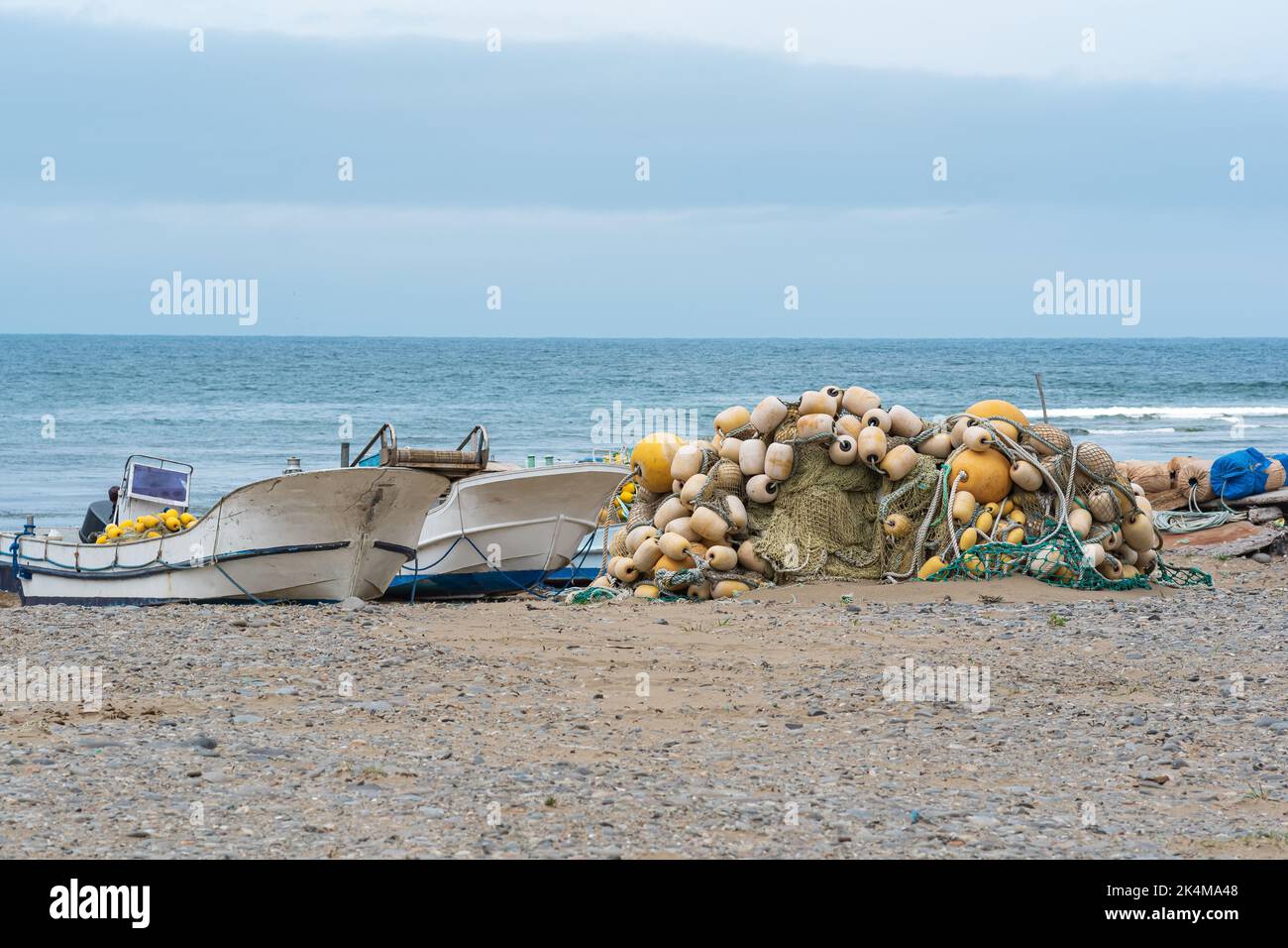 small fishing boats and nets on the seashore Stock Photo Alamy