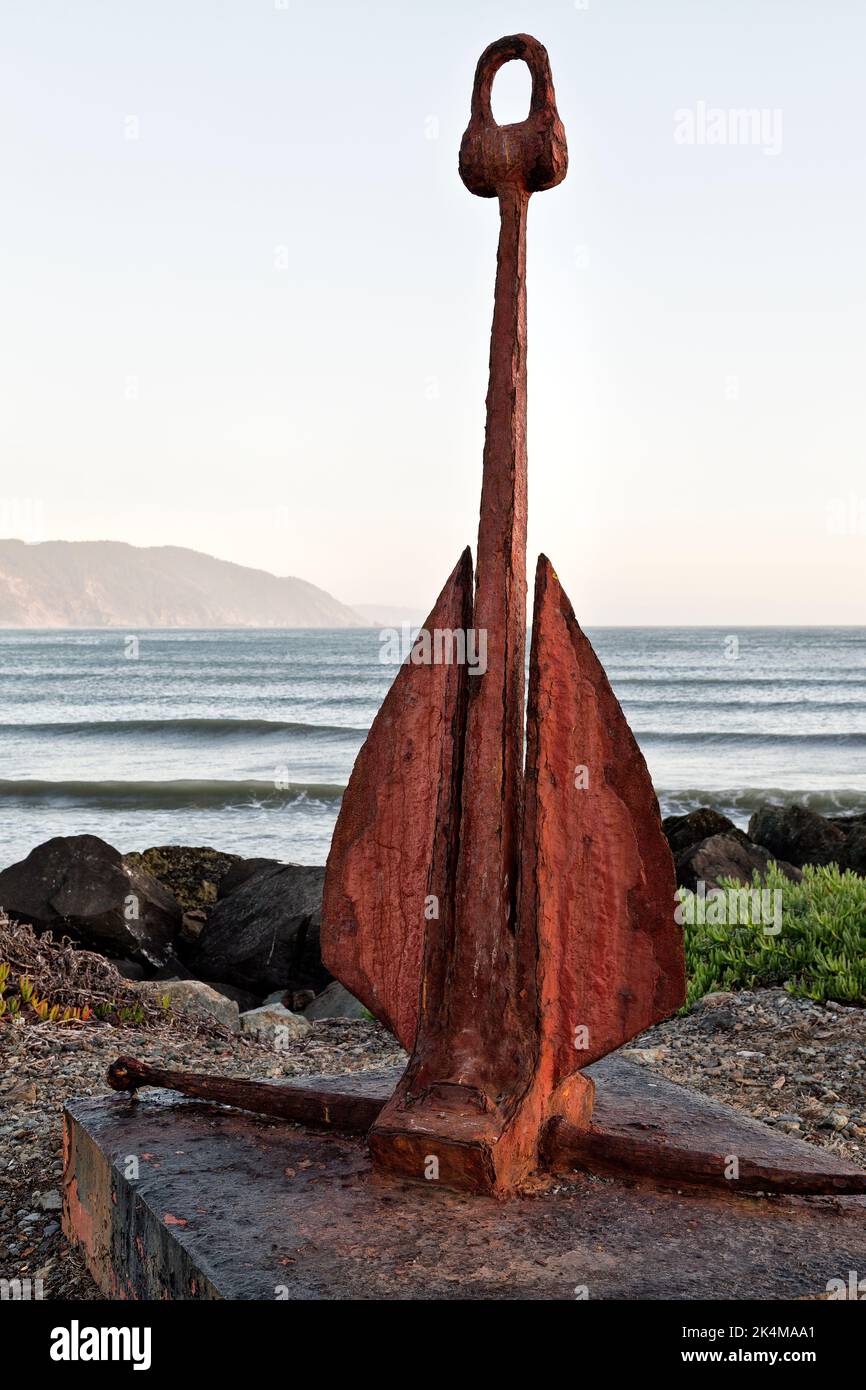 Classic 'Danforth'  fluke-type rusty boat anchor,  overlooking bay,  California. Stock Photo