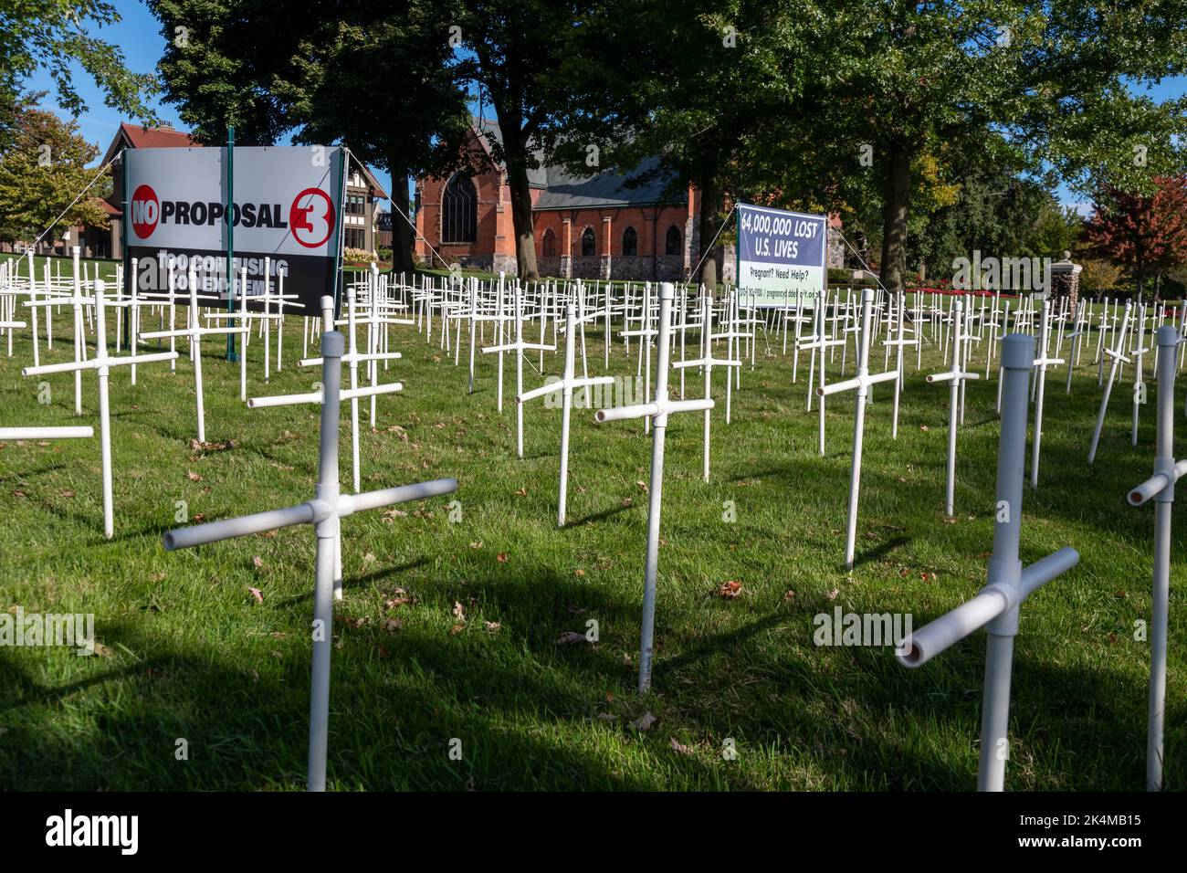 Grosse Pointe Farms, Michigan, USA. 3rd Oct, 2022. As Michigan prepares to vote on Proposal 3, which would enshrine the right to abortion in the state's constitution, St. Paul on the Lake Catholic Church displays dozens of crosses on its lawn, with signs opposing the measure. The display has become controversial; city resident Edsel Ford II said it 'diminish[es] the character of our neighborhood.' Credit: Jim West/Alamy Live News Stock Photo