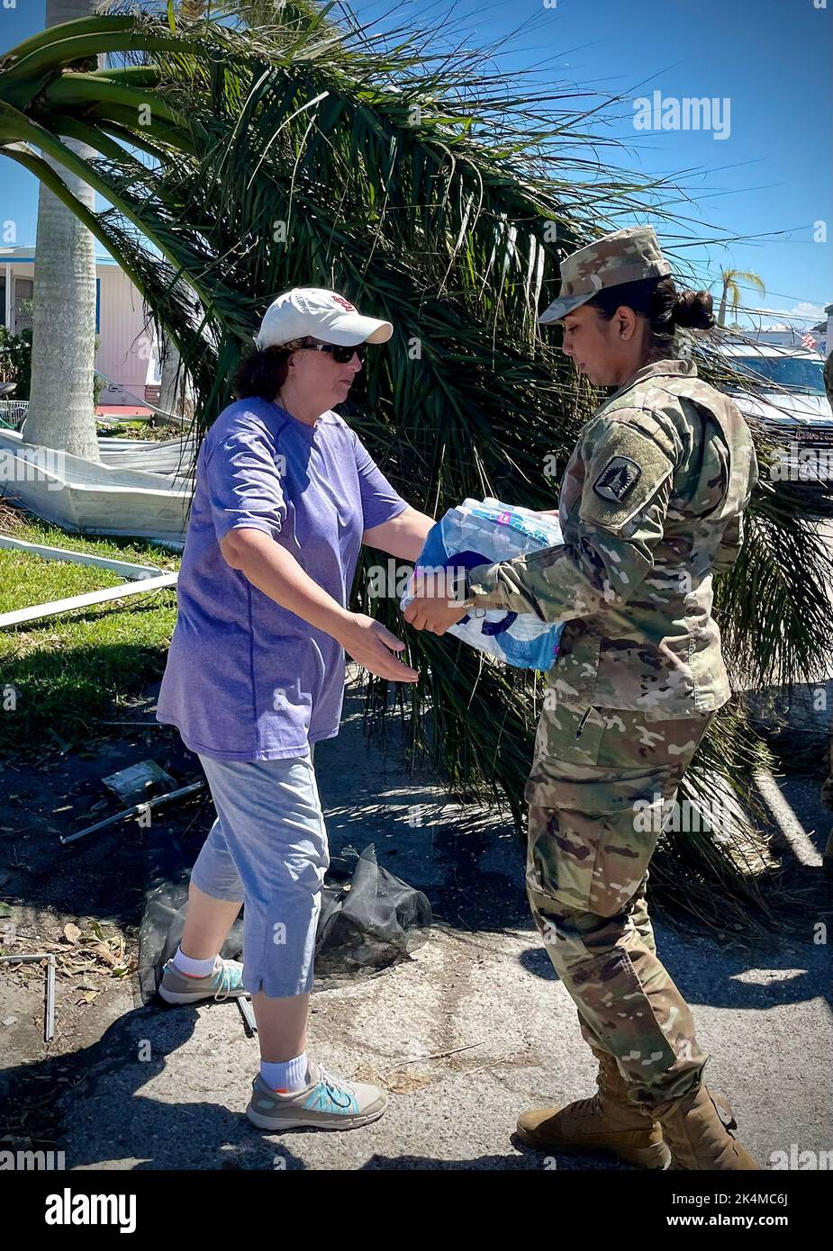 Soldiers from 1–265th Air Defense Artillery (ADA) deliver food and water to neighborhoods devastated by Hurricane Ian, Port Charlotte, Florida, Oct. 2, 2022. We have forces operating throughout the state, providing assistance to the areas of greatest need. Stock Photo