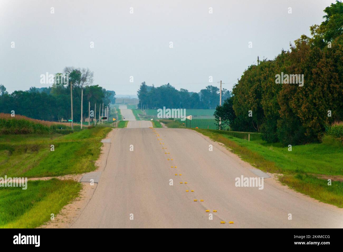 Rolling asphalt country road in the midwest town of Dexter Minnesota