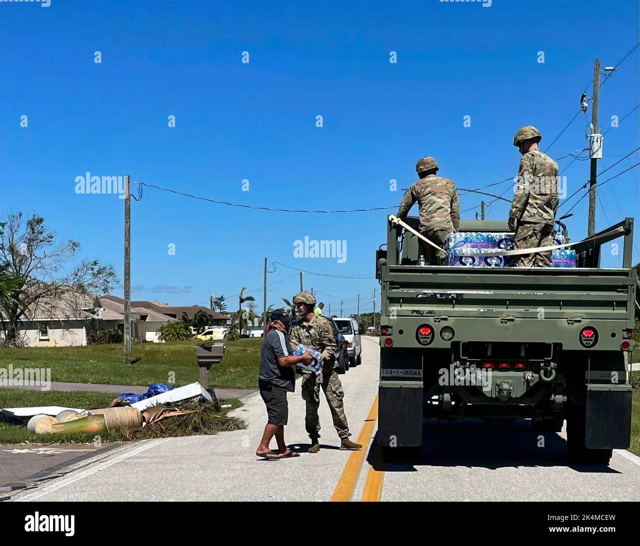 Soldiers from 1–265th Air Defense Artillery (ADA) deliver food and water to neighborhoods devastated by Hurricane Ian, Port Charlotte, Fla., Oct. 2, 2022. We have forces operating throughout the state, providing assistance to the areas of greatest need. Stock Photo