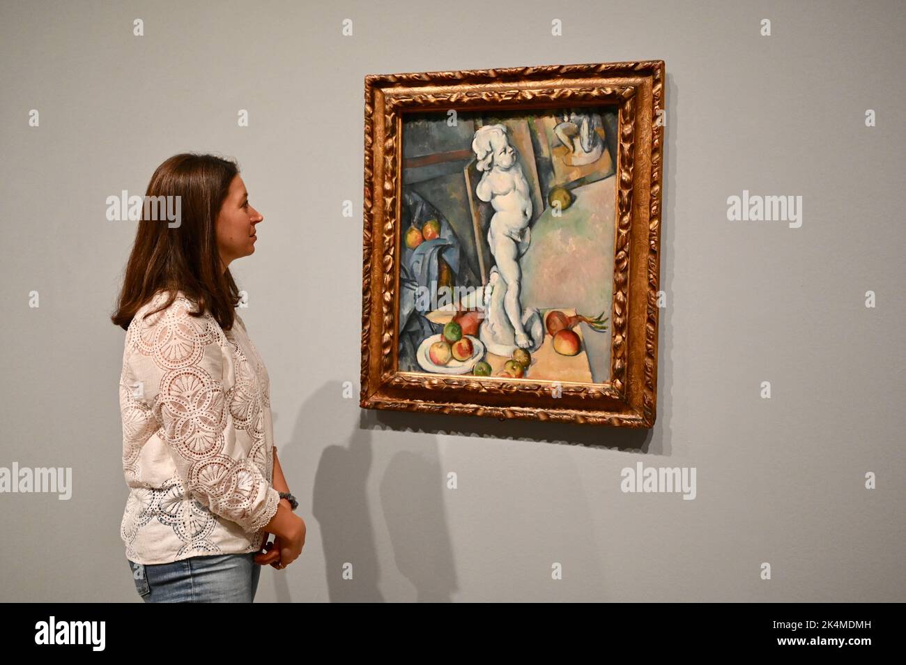 London, UK. A gallery employee views 'Still Life with Plaster Cupid' (c1894). Press Preview of The EY Exhibition: Cezanne. 5 October 2022- 12 March 2023. Tate Modern, Bankside. Stock Photo