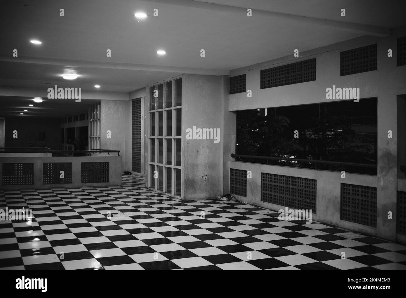 Monochrome photo of a room with a chessboard patterned floor in the Cicalengka area - Indonesia Stock Photo