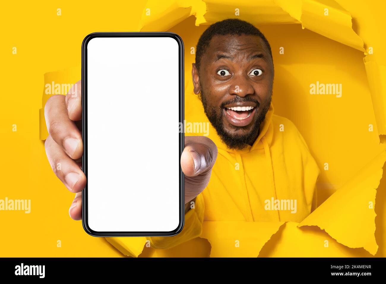 Unbelievable offer. Shocked black man holding smartphone with empty
