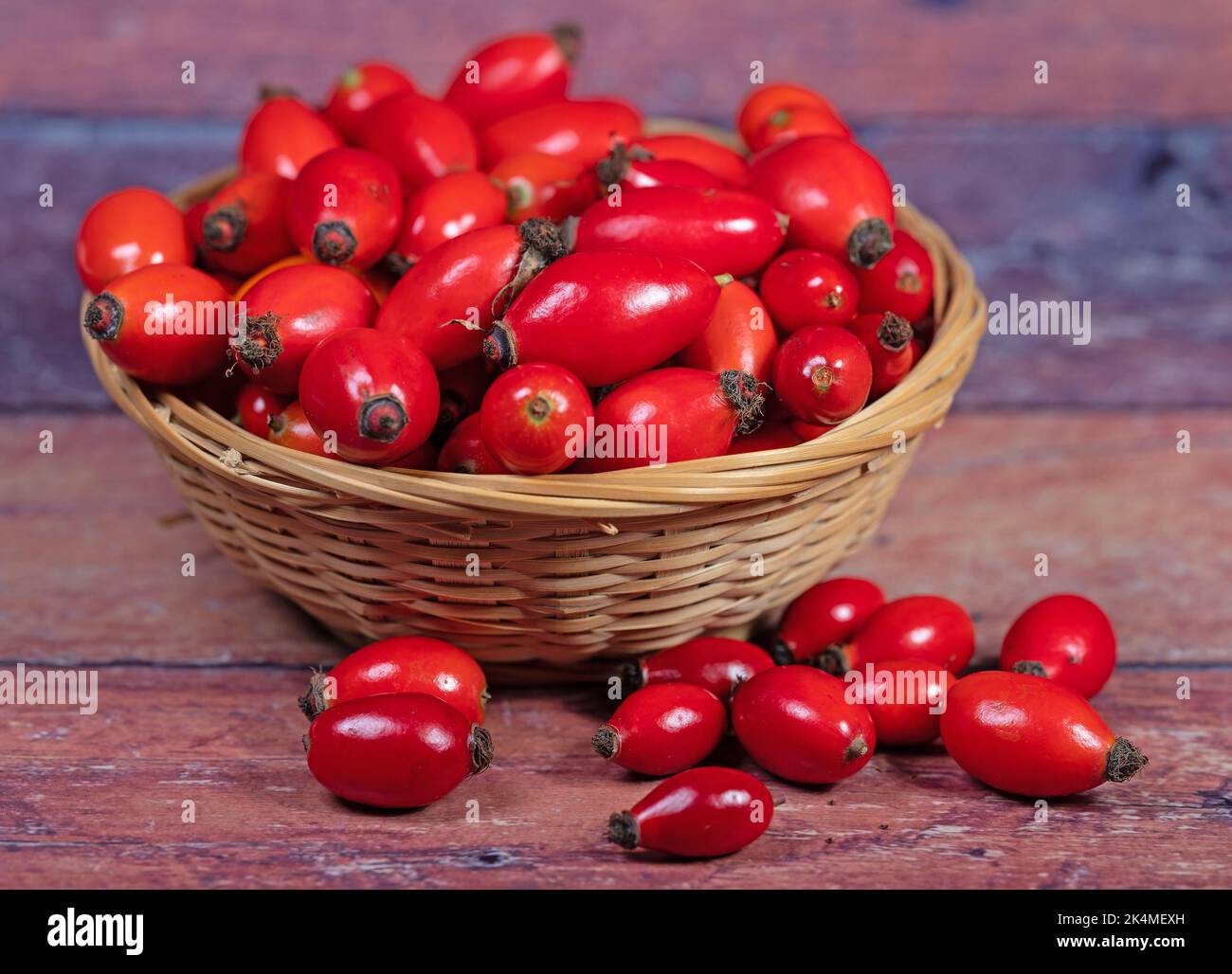 Ripe rose hips in the basket Stock Photo