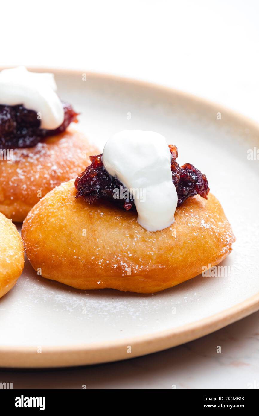 fried muffins with plum jam and sour cream Stock Photo Alamy