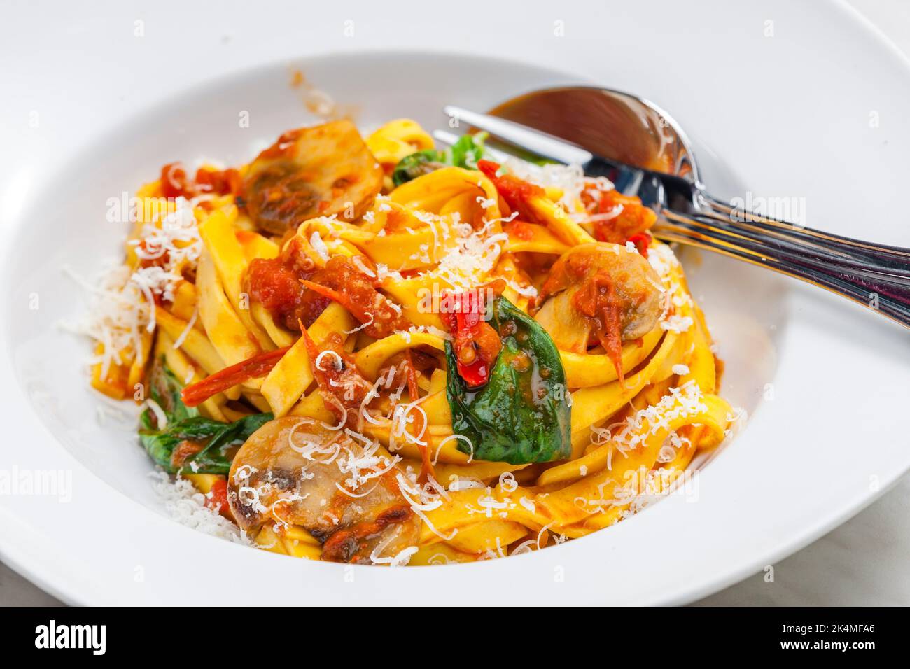 https://c8.alamy.com/comp/2K4MFA6/pasta-tagliatelle-with-tomato-saucechampignon-and-basil-leaves-2K4MFA6.jpg