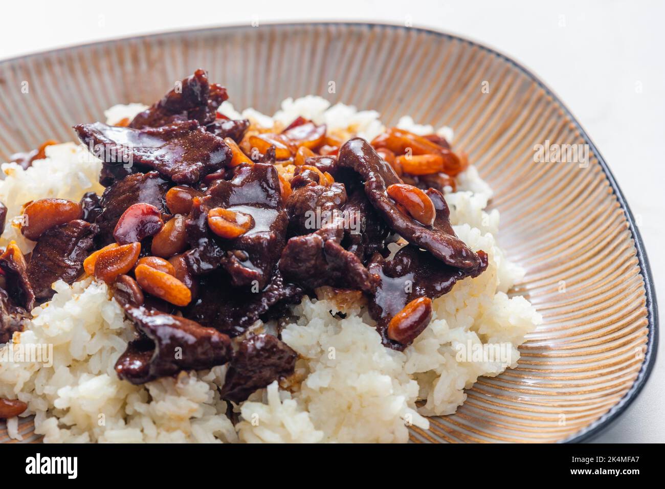 beef meat with soya sauce and peanuts served with white rice Stock