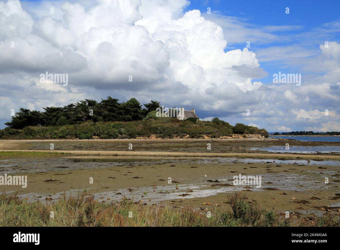 Cumulonimbus clouds and view from Iles de Brouel at low tide towards