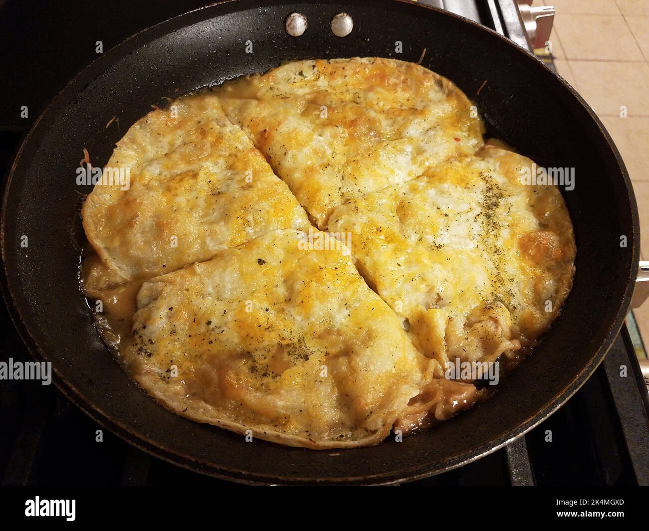 tortillas with cheese cooking in a frying pan or skillet on the stove