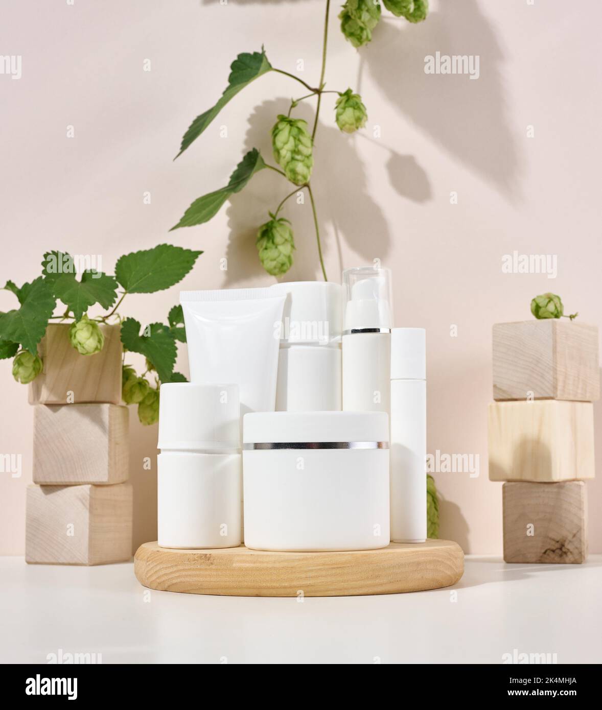 White plastic container tube, a jar with a lid for cosmetics on a beige