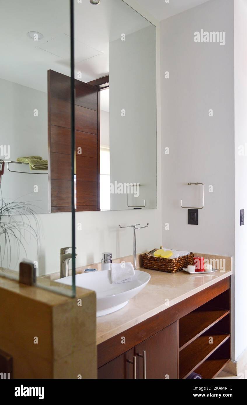 Spacious bathroom in gray tones with heated floors, freestanding tub