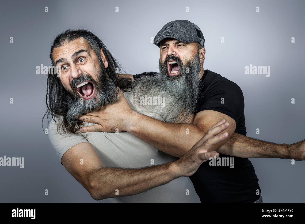 brawl between unshaven men studio shot Stock Photo