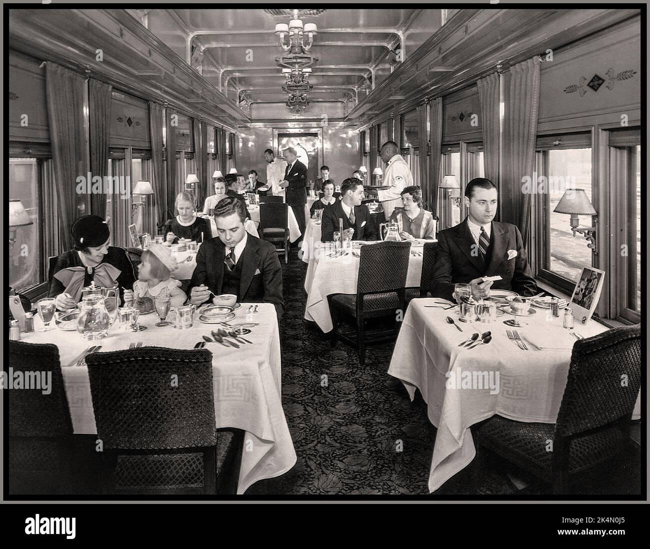 Luxury 1930s American Rail Travel on Pullman Luncheon Car with passengers enjoying a meal on North Coast Limited first class restaurant car, 1934. USA Stock Photo