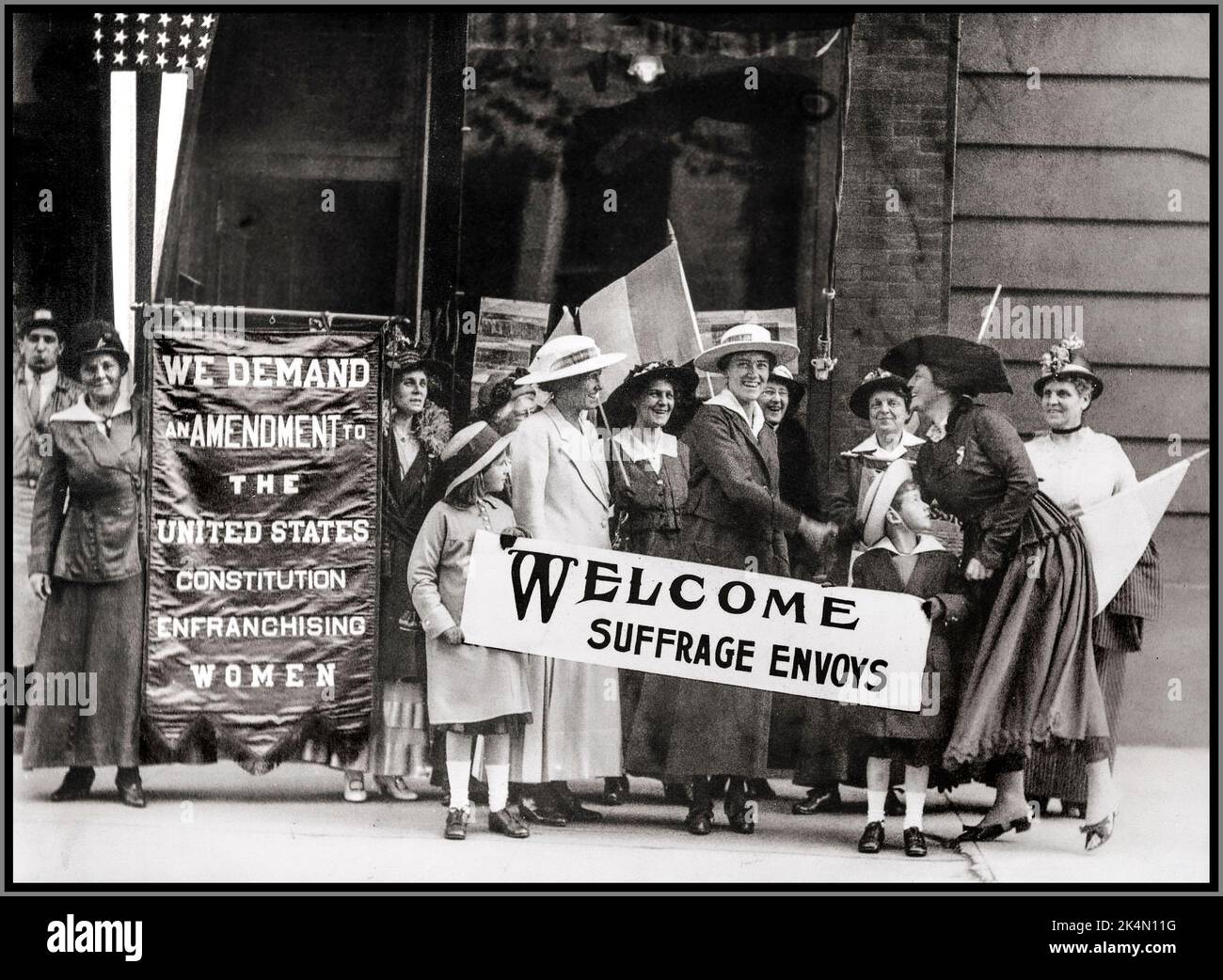 Suffrage USA 19th amendment America Constitution. Women on an American street with banners ‘ WE DEMAND AMENDMENT’ fighting as Suffragettes for the right to vote in the USA. Stock Photo