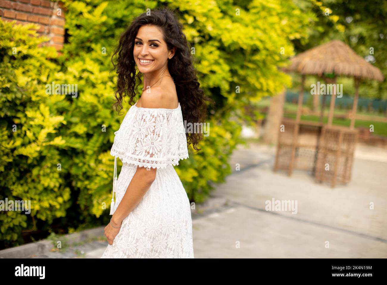 Young curly hair woman in the park Stock Photo - Alamy