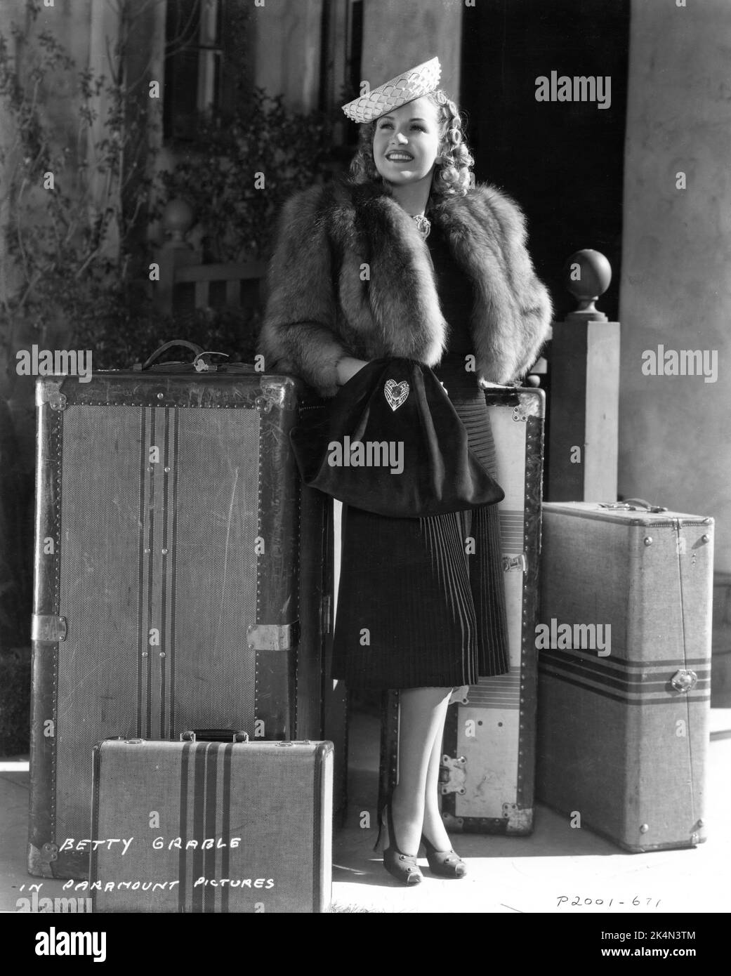 BETTY GRABLE 1939 Fashion Portrait with Luggage publicity for MAN ABOUT TOWN 1939 director MARK SANDRICH Paramount Pictures Stock Photo