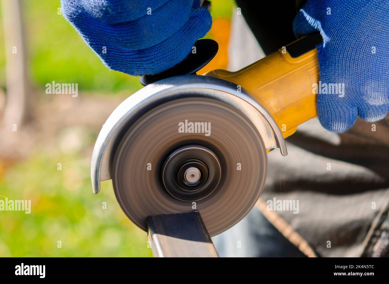 Closeup on the sides fly bright sparks from the angle grinder machine