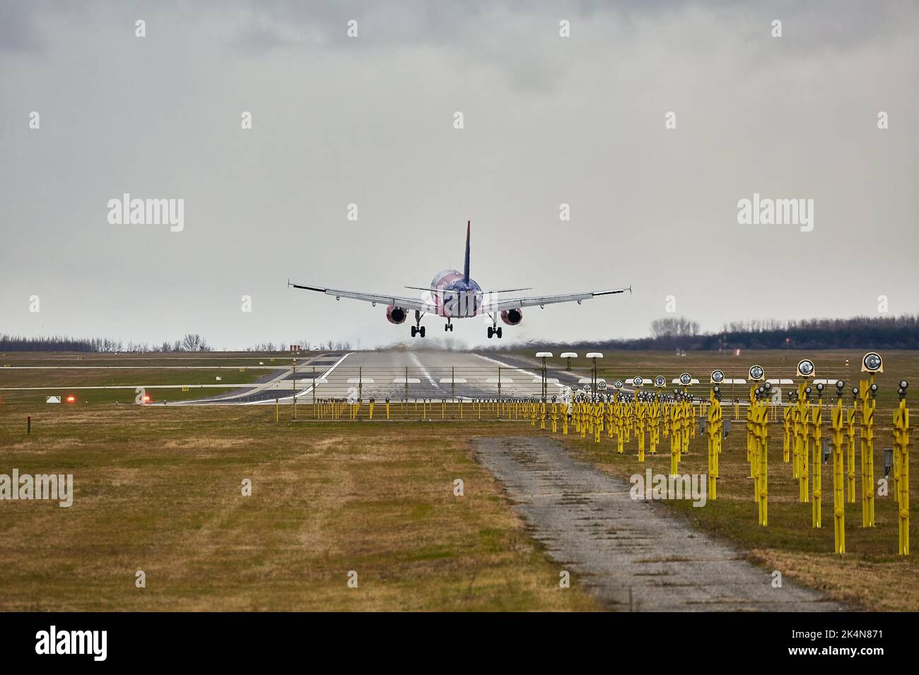 Plane landing on runway Stock Photo