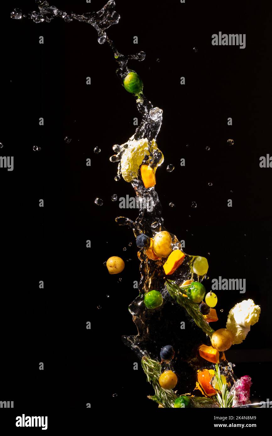 thrown in the air of vegetables and fruits in water Stock Photo