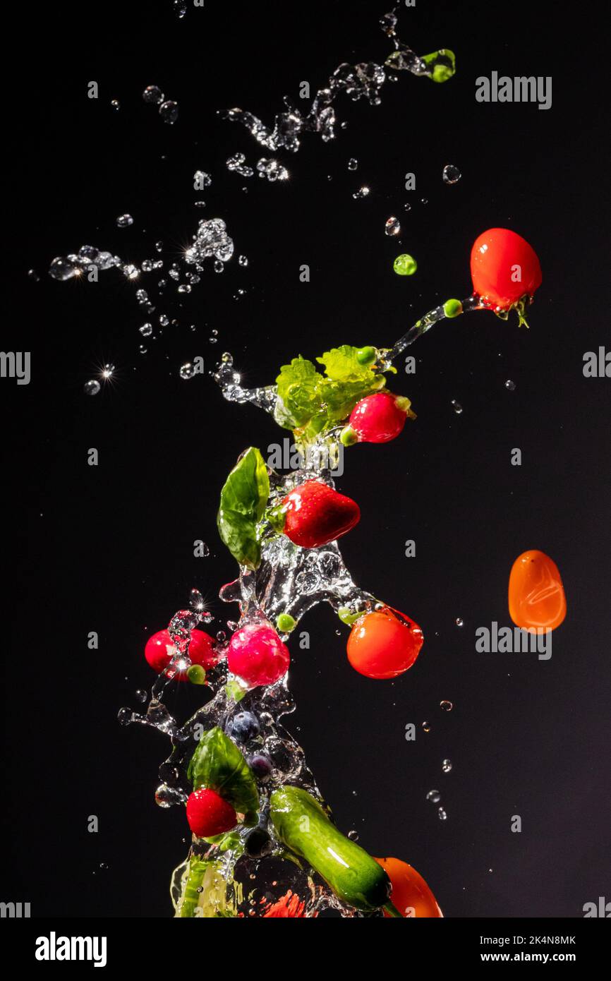 thrown in the air of vegetables and fruits in water Stock Photo