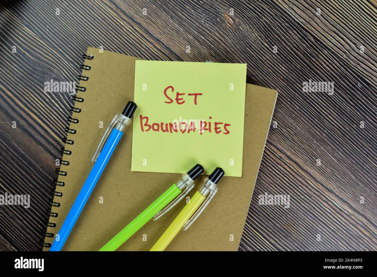Concept of Set Boundaries write on sticky notes isolated on Wooden Table. Stock Photo
