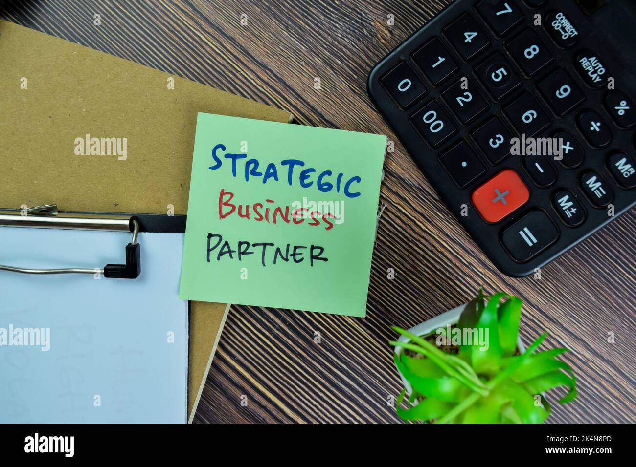 Concept of Strategic Business Partner write on sticky notes isolated on Wooden Table. Stock Photo