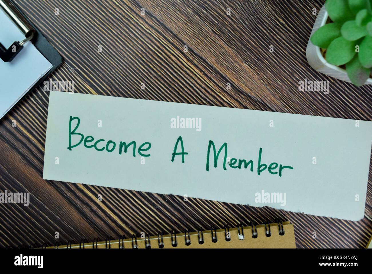 Concept of Become A member write on sticky notes isolated on Wooden Table. Stock Photo