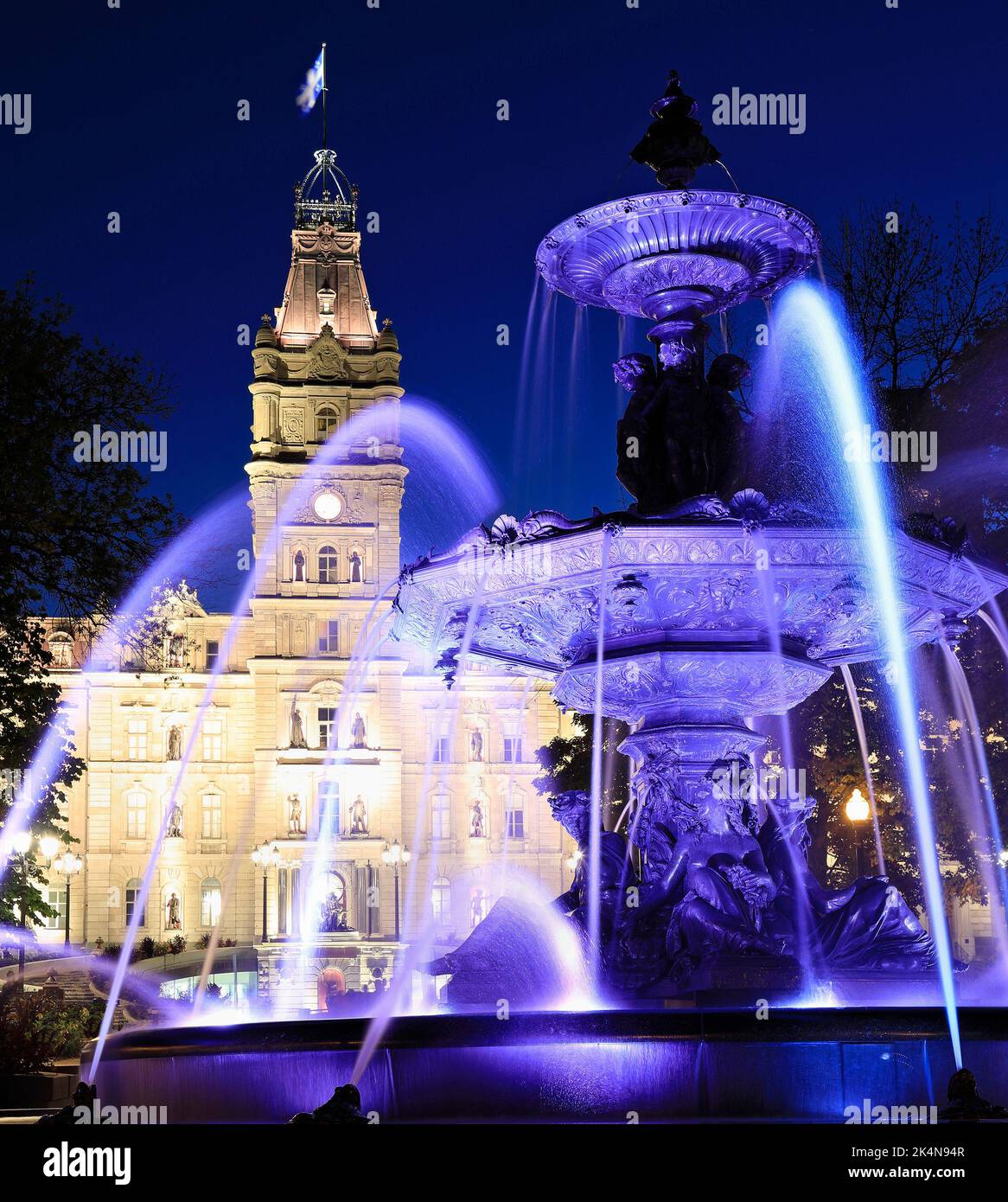 The Quebec Parliament Building and the Fontaine de Tourny illuminated at dusk in Quebec City, Quebec, Canada Stock Photo