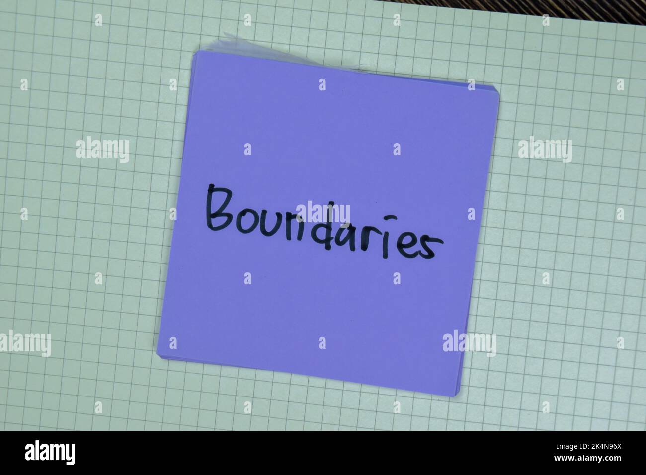Concept of Boundaries write on sticky notes isolated on Wooden Table. Stock Photo