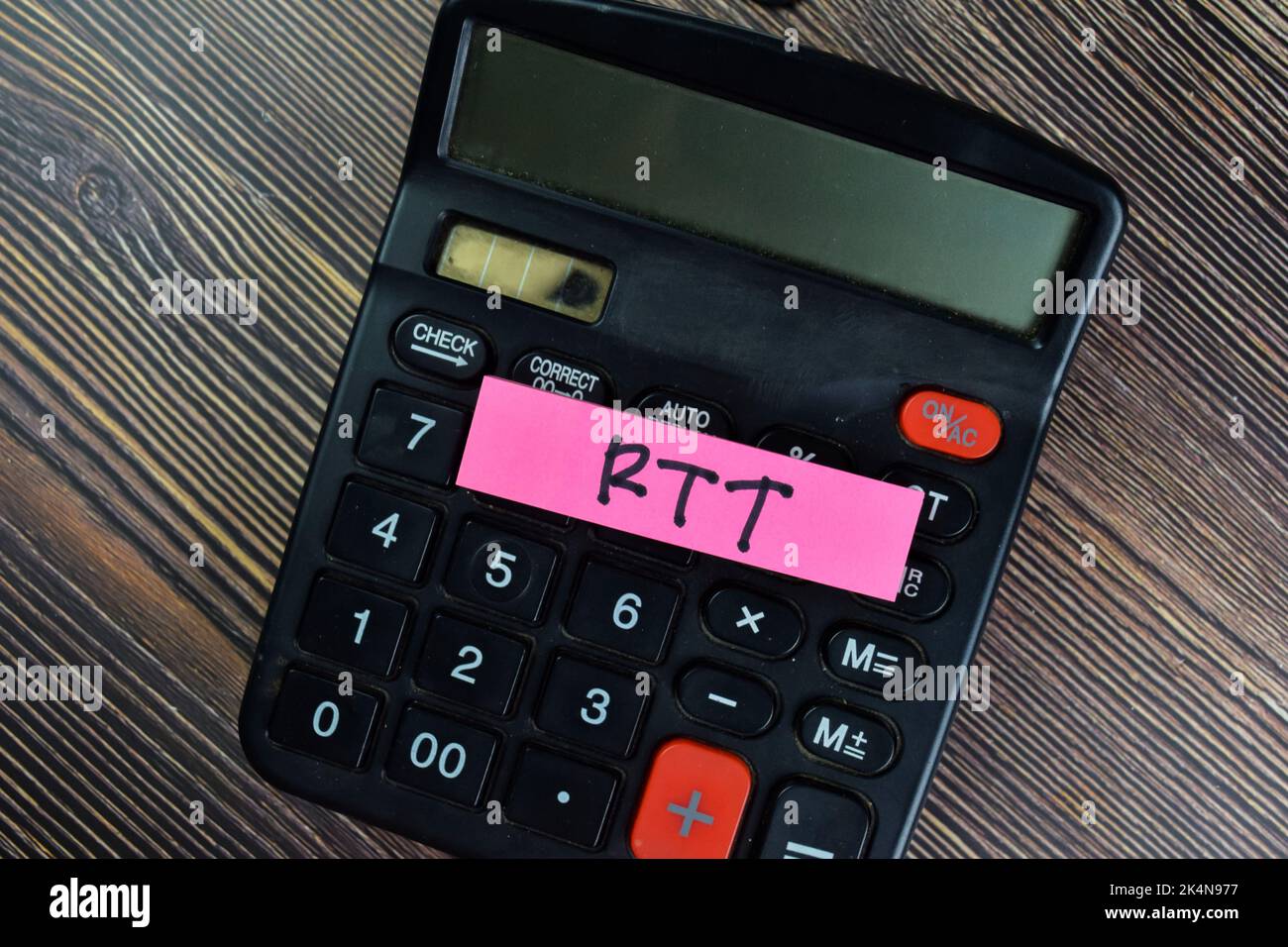 Concept of RTT write on sticky notes with calculator isolated on Wooden Table. Stock Photo