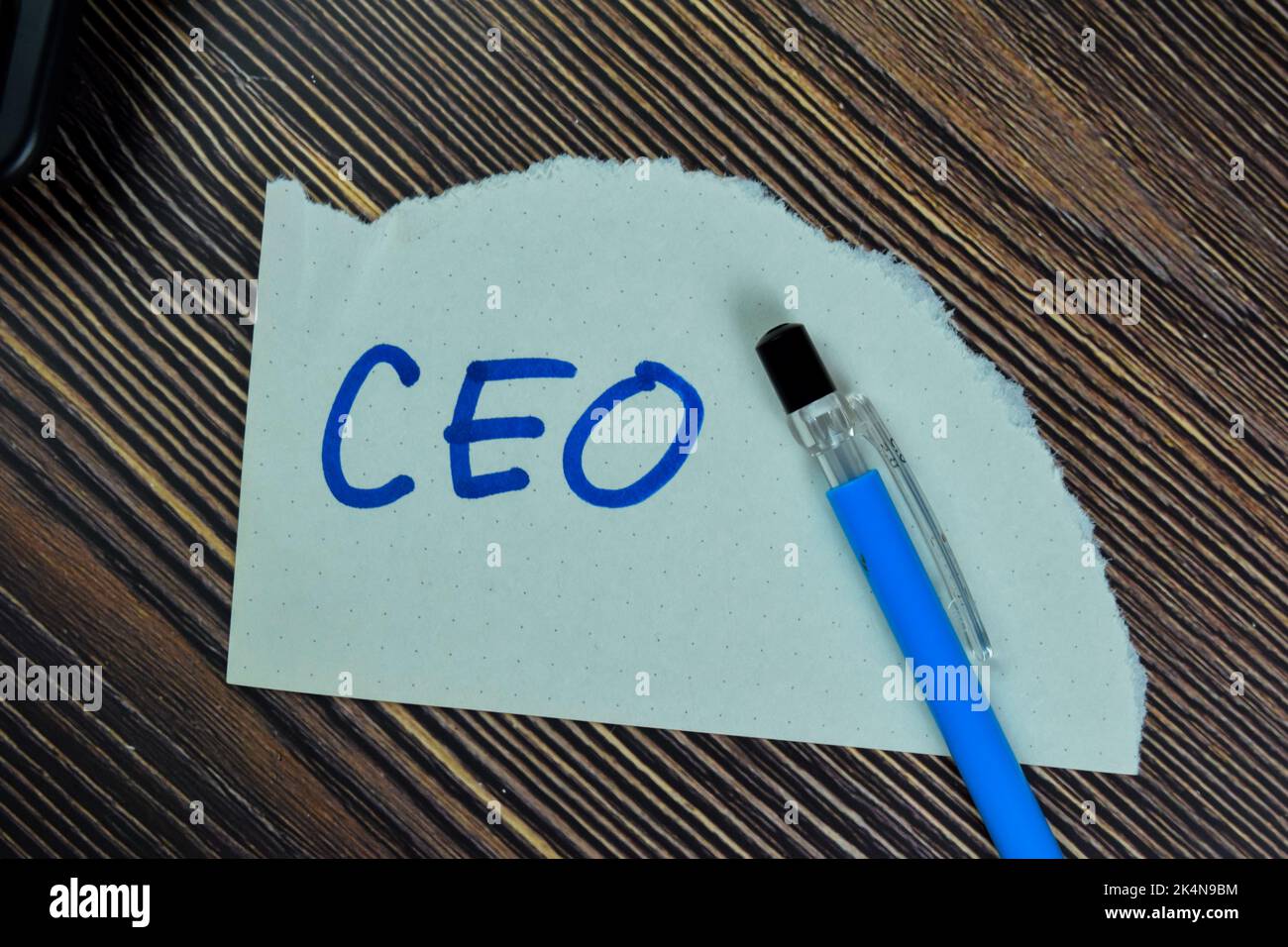Concept of CEO write on sticky notes isolated on Wooden Table. Stock Photo