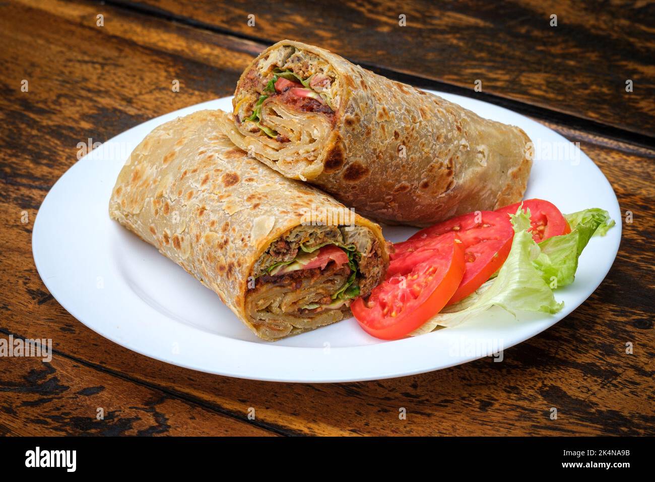 Ugandan Rolex, commonly referred to Rolex, is a popular item in Uganda, combining an egg omelette and vegetables wrapped in a chapati Stock Photo - Alamy