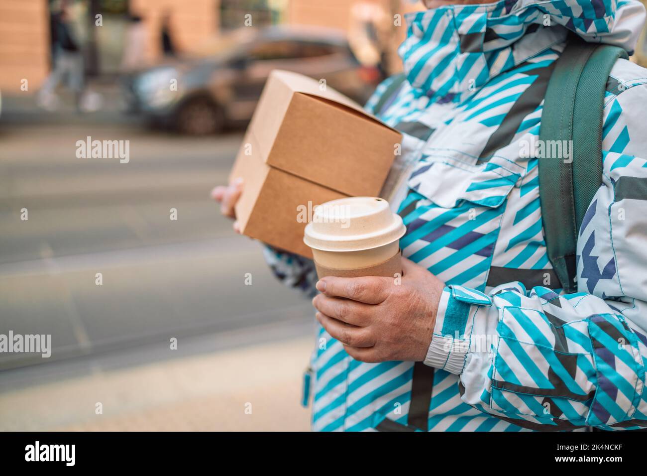 Craft packaging of delivered food in hands. Stack of food delivery