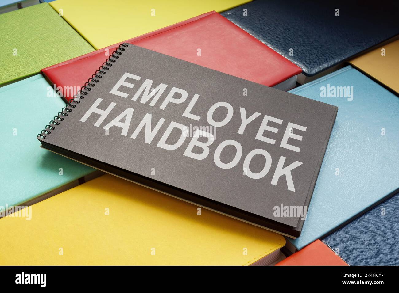 An employee handbook on the colorful books. Stock Photo