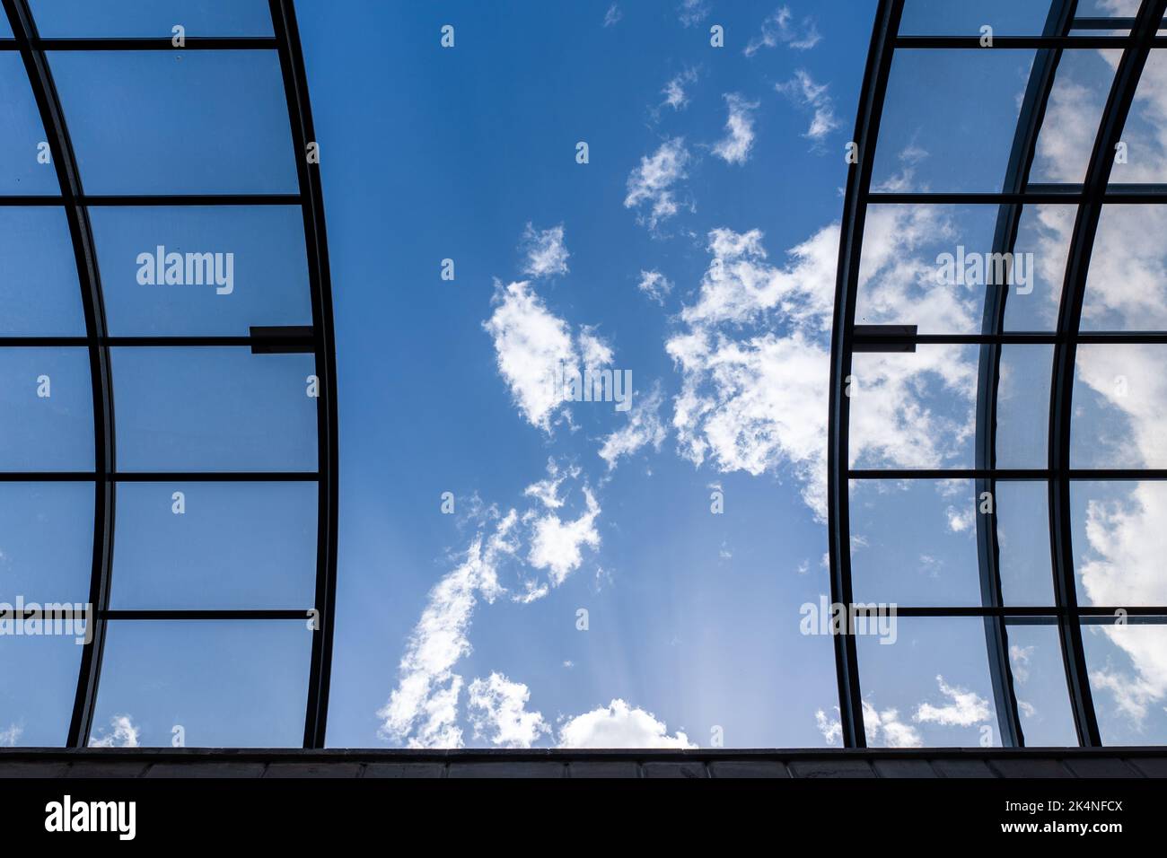 Glass ceiling with black grids. Abstract black stripes texture background, against the blue sky with clouds. High quality photo Stock Photo
