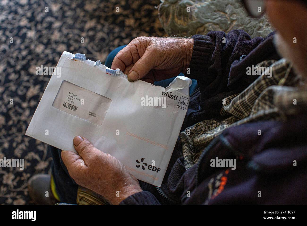 London, UK. Sept 29 2022 .Close up of hand taking energy bill out of envelope. Stock Photo