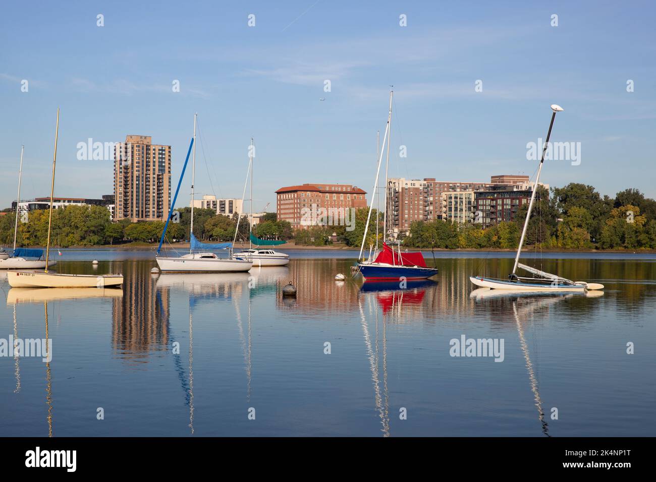 Sailboats at the Minneapolis Sailing Center marina on Lake Bde Maka Ska, Minnesota. The 1928 Beach Club Residences building is in the background. Stock Photo