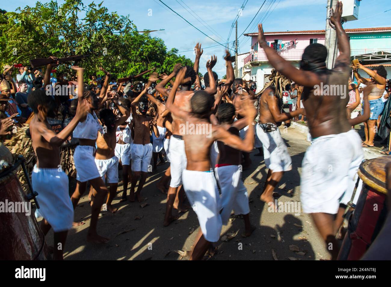 Members of the cultural event Nego Fugido sing and sit on the ground ...