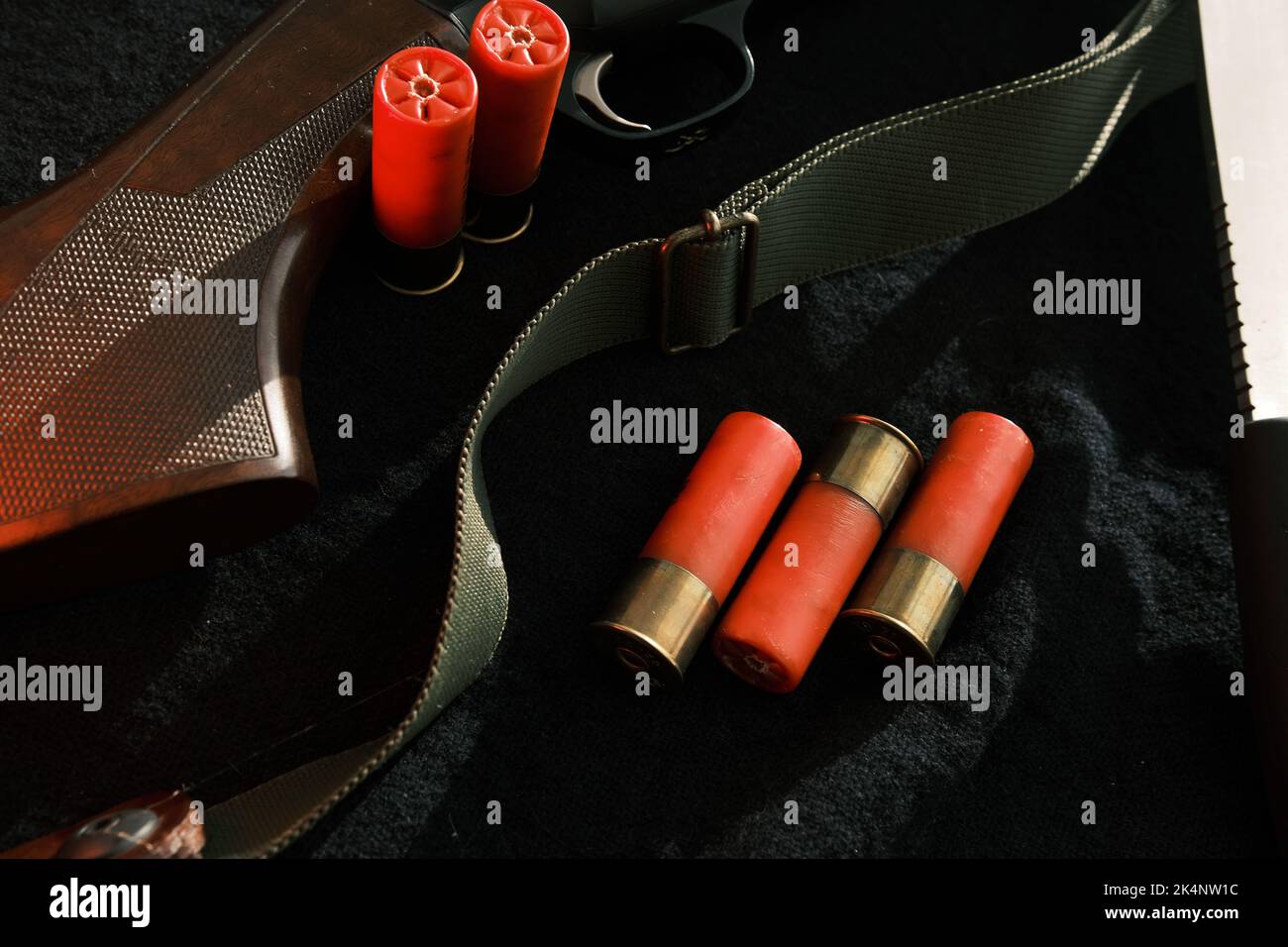 Weapon on black cloth: knife, rifle, shells,top view. Top view of knife ...