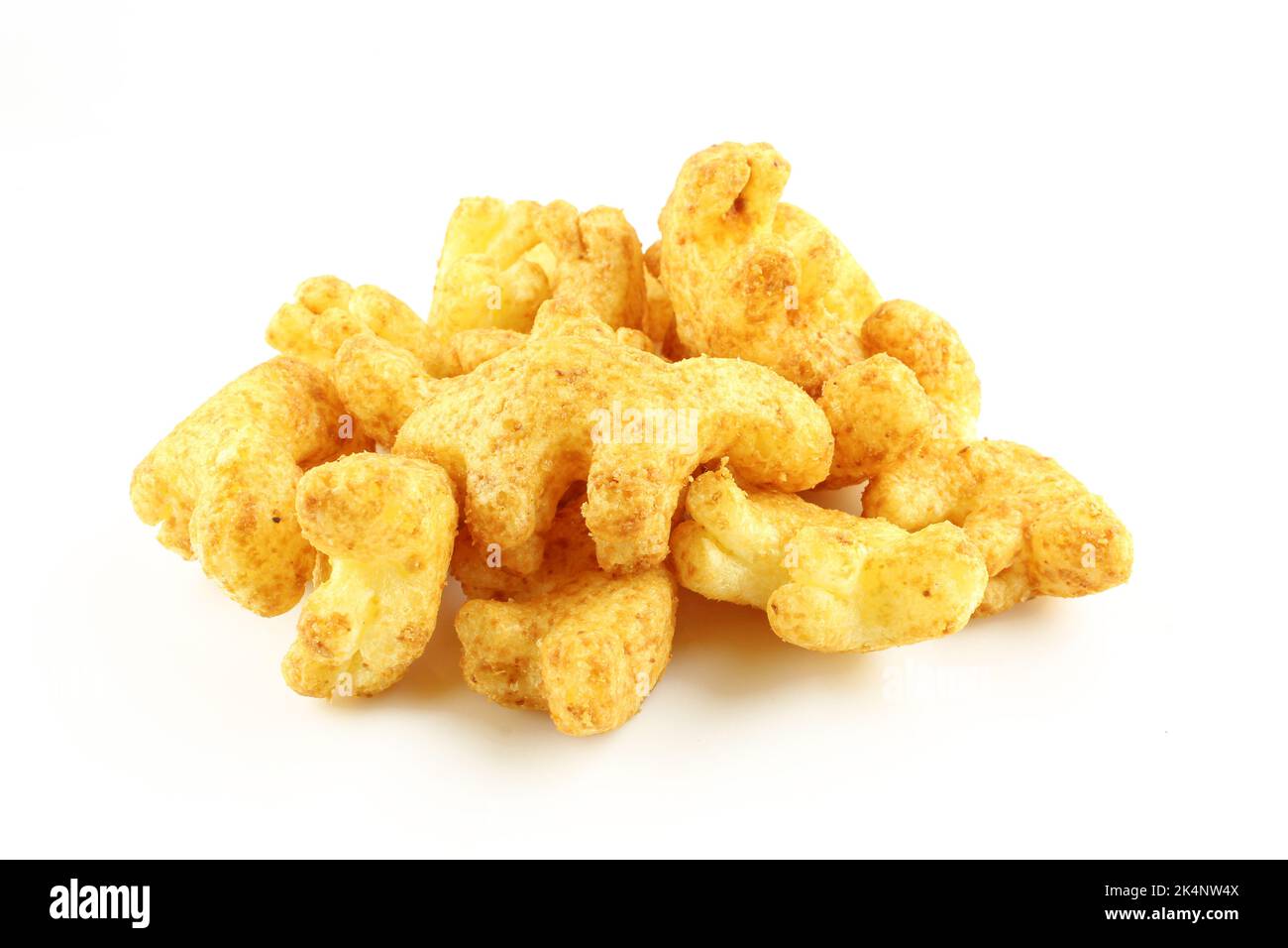 Pile of dinosaur shaped peanut puff snacks isolated on white background