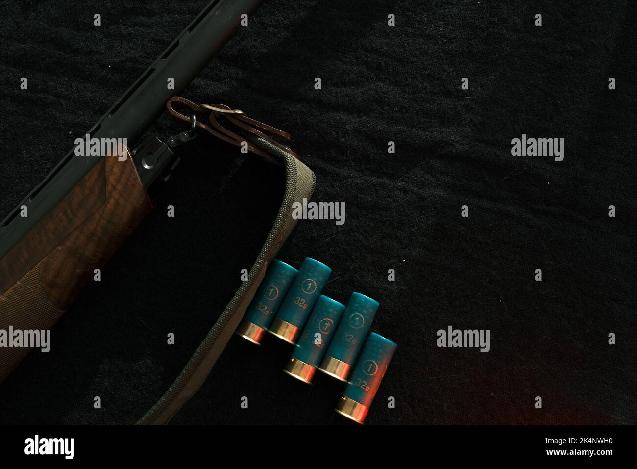 Weapon on black cloth: rifle, shells,top view. Top view of rifle
